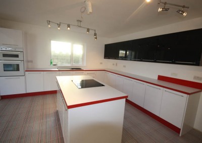 Modern Red And White Worktops with Red Kickboards